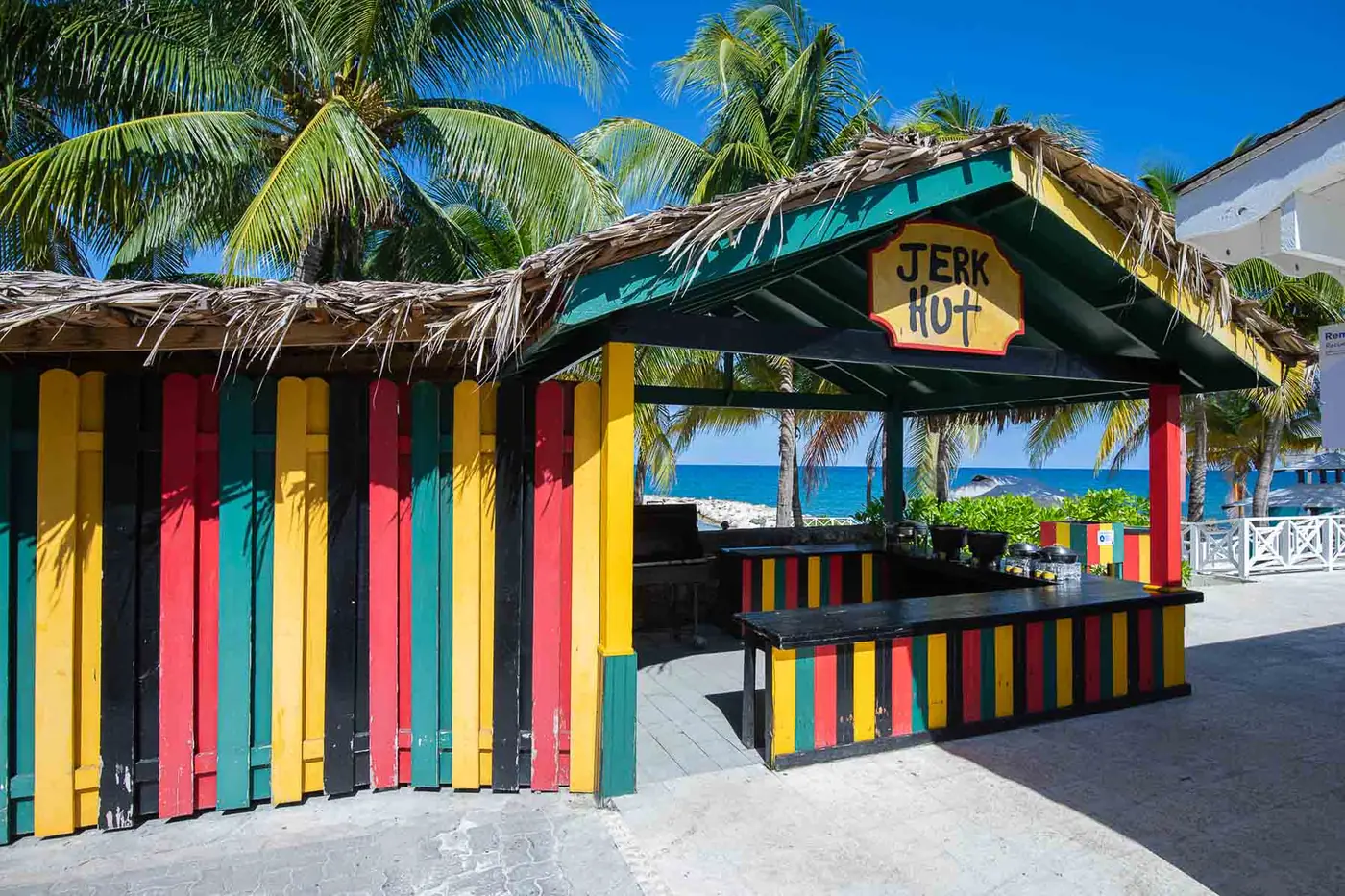 The thatched beachside Jerk Hut, painted red, gold and green