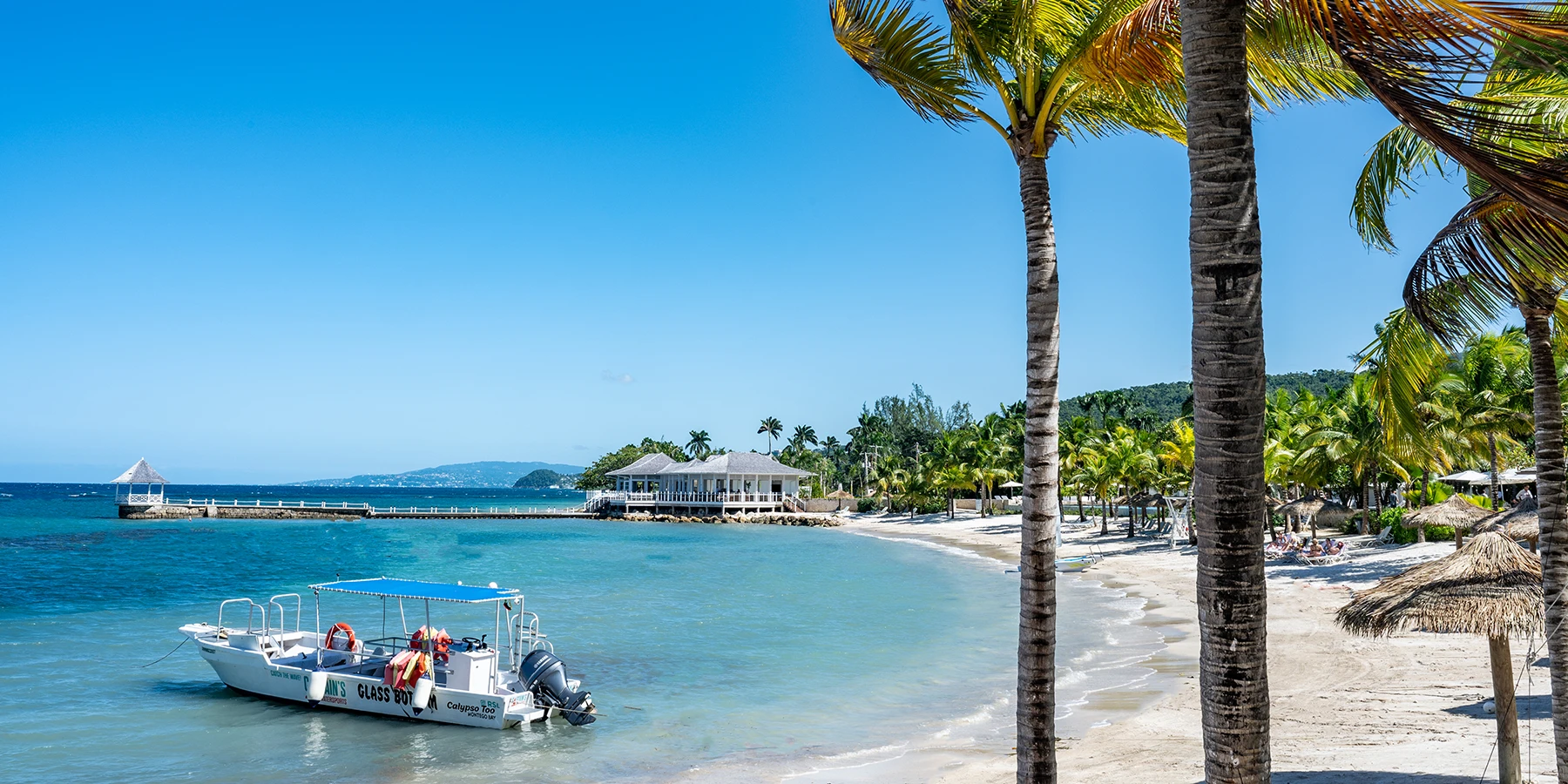 Tryall's private beach — palms leaning over white sand and turquoise water
